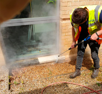 A Locus Services operative carrying out commercial pressure washing